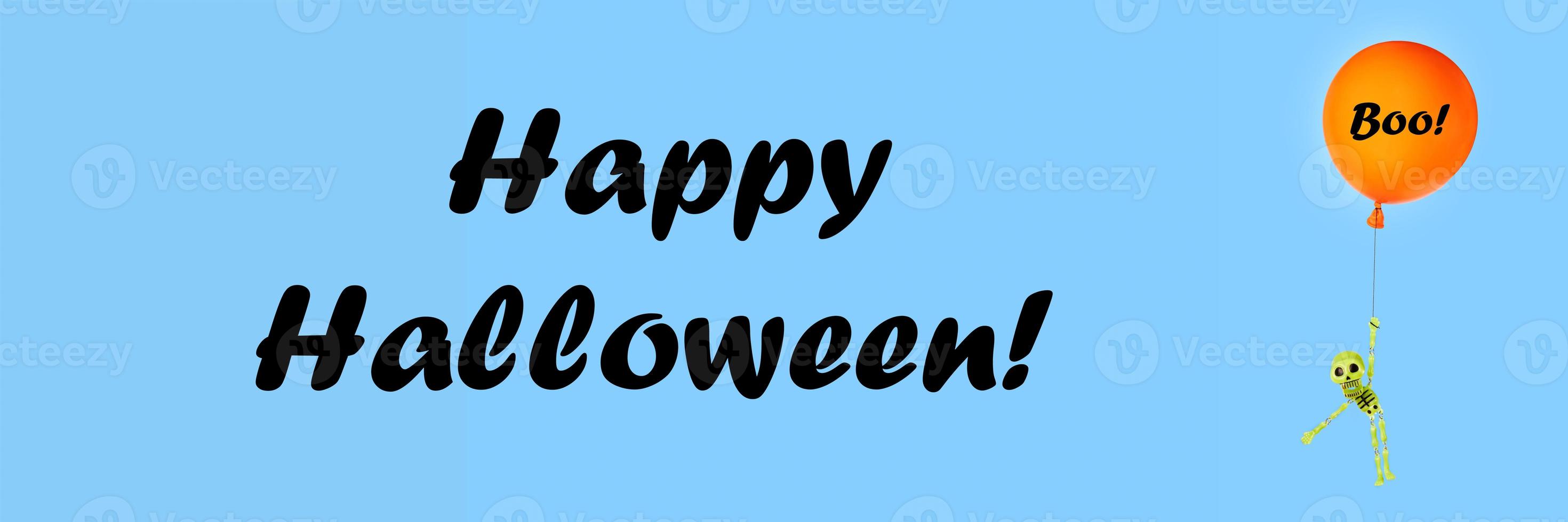 Halloween blue banner with letters Happy Halloween and with green skeleton flying on orange balloon. photo