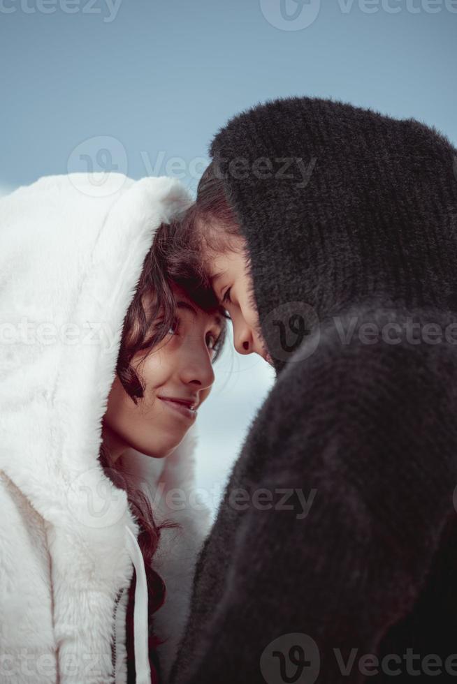 Portrait of two sisters playing together and they are happy in the winter photo