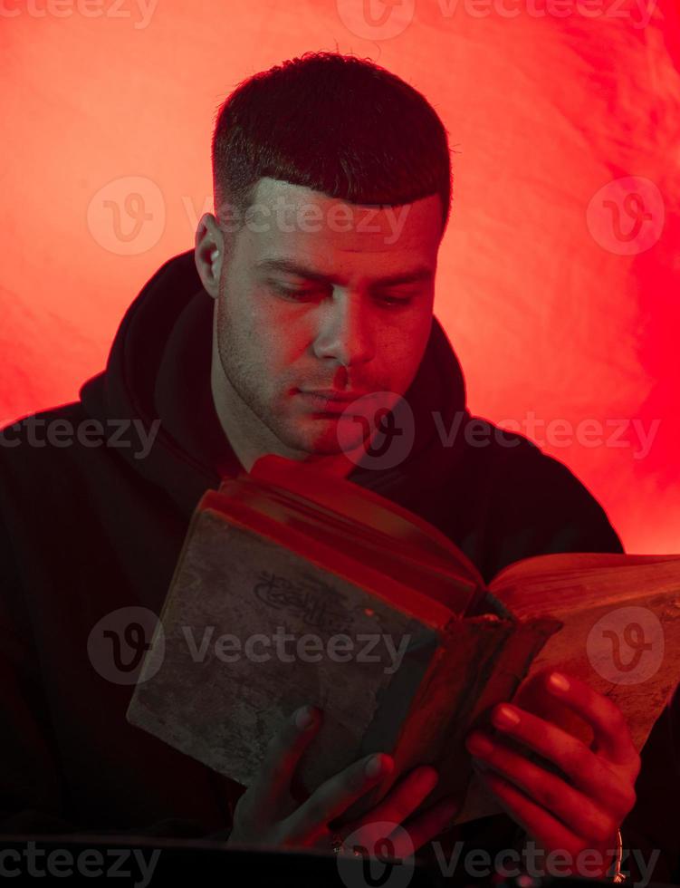 A young man browses a historical book and reflects on the reality we live in photo