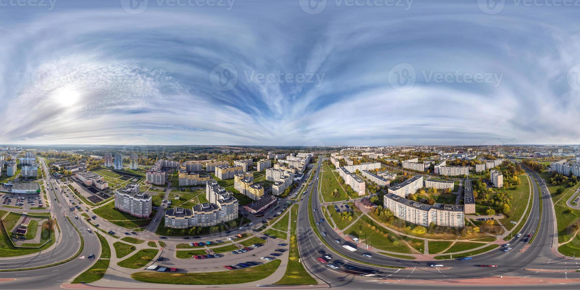 aerial full seamless spherical hdri 360 panorama view above road junction with traffic in residential complex with high-rise buildings in equirectangular projection. photo