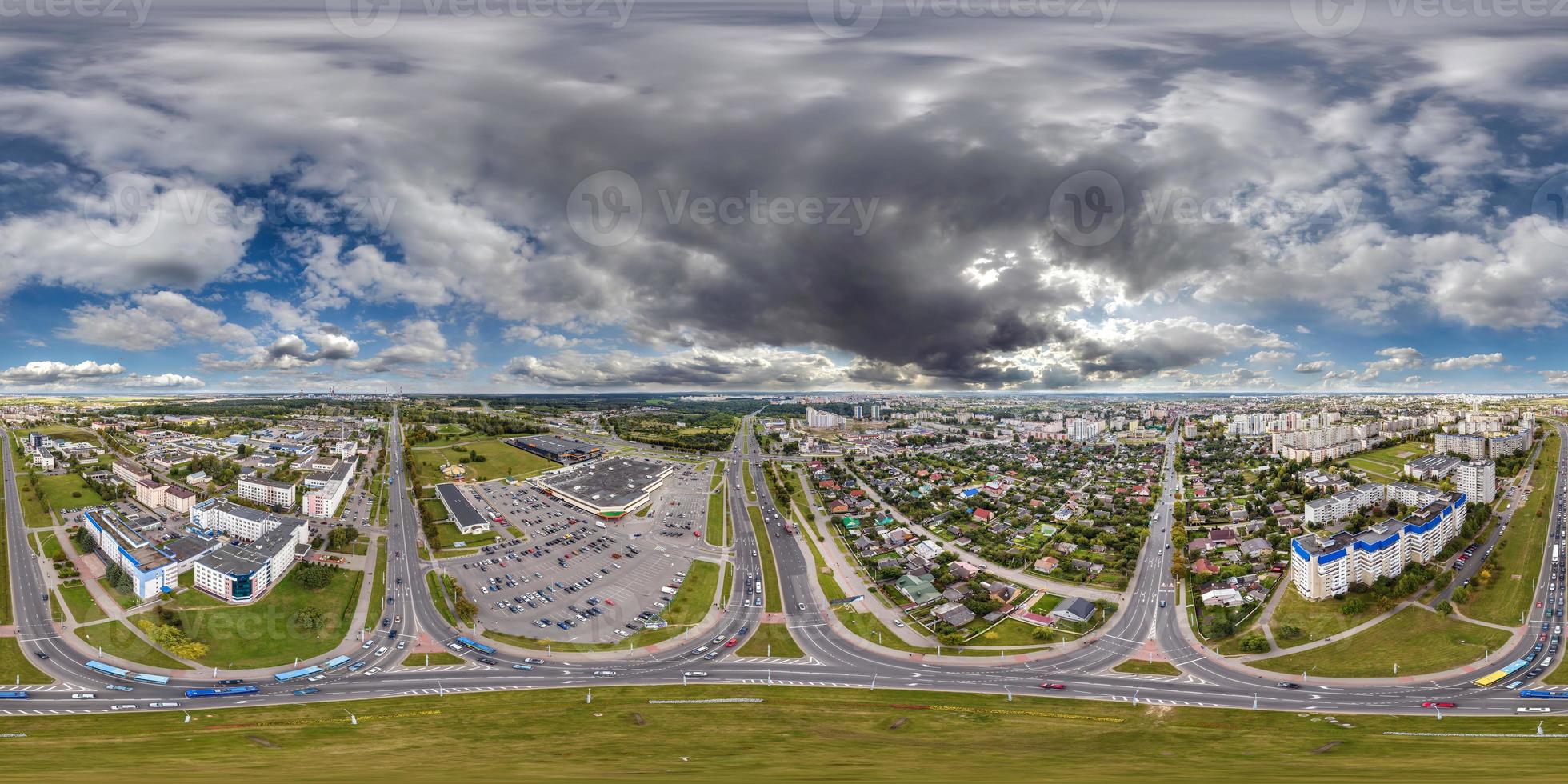 aerial full seamless spherical hdri 360 panorama view above road junction with traffic in small provincial town with private sector and high-rise apartment buildings in equirectangular projection. photo