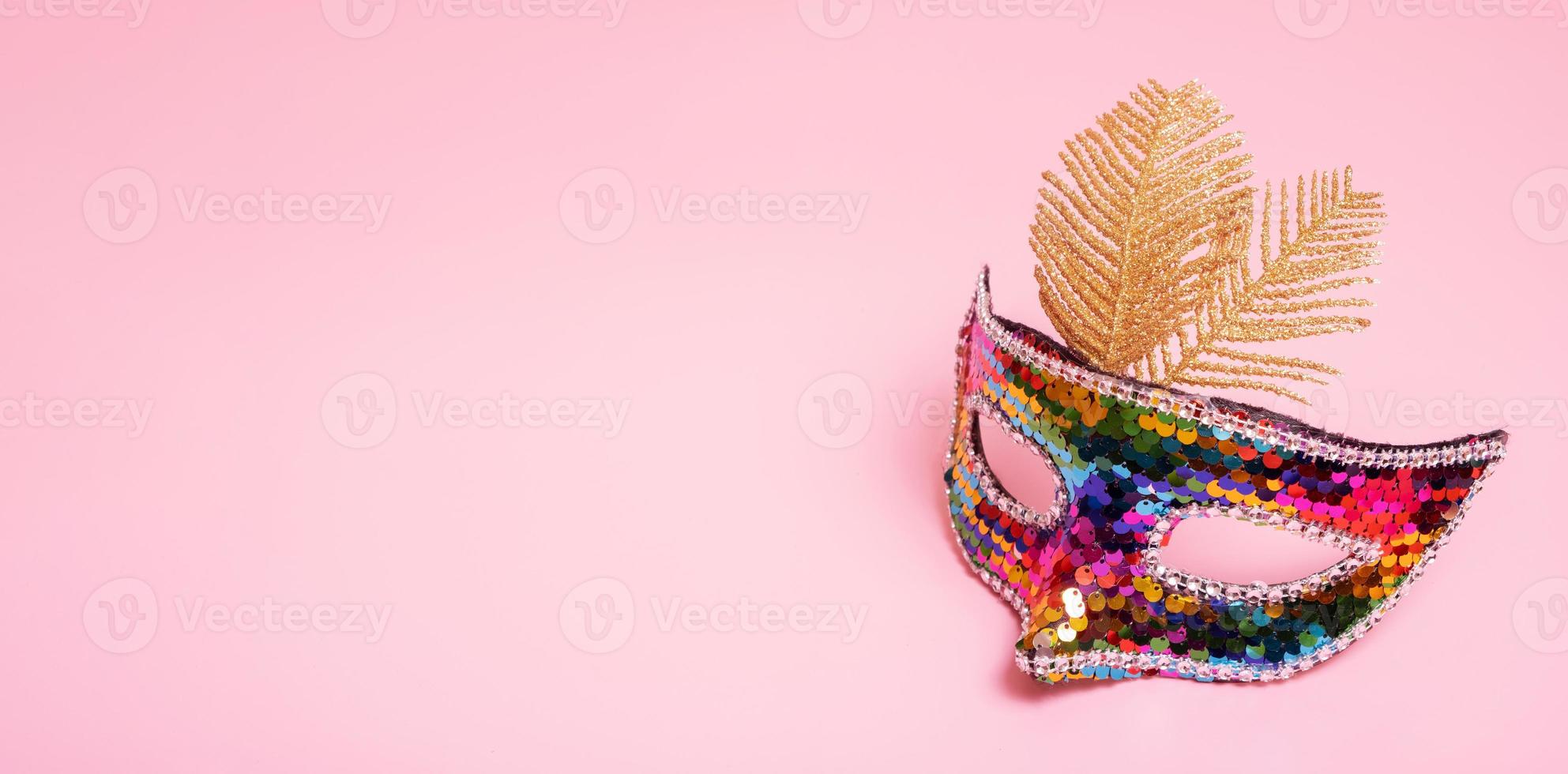 Festive face mask for carnival celebration on colored background. Copy space photo