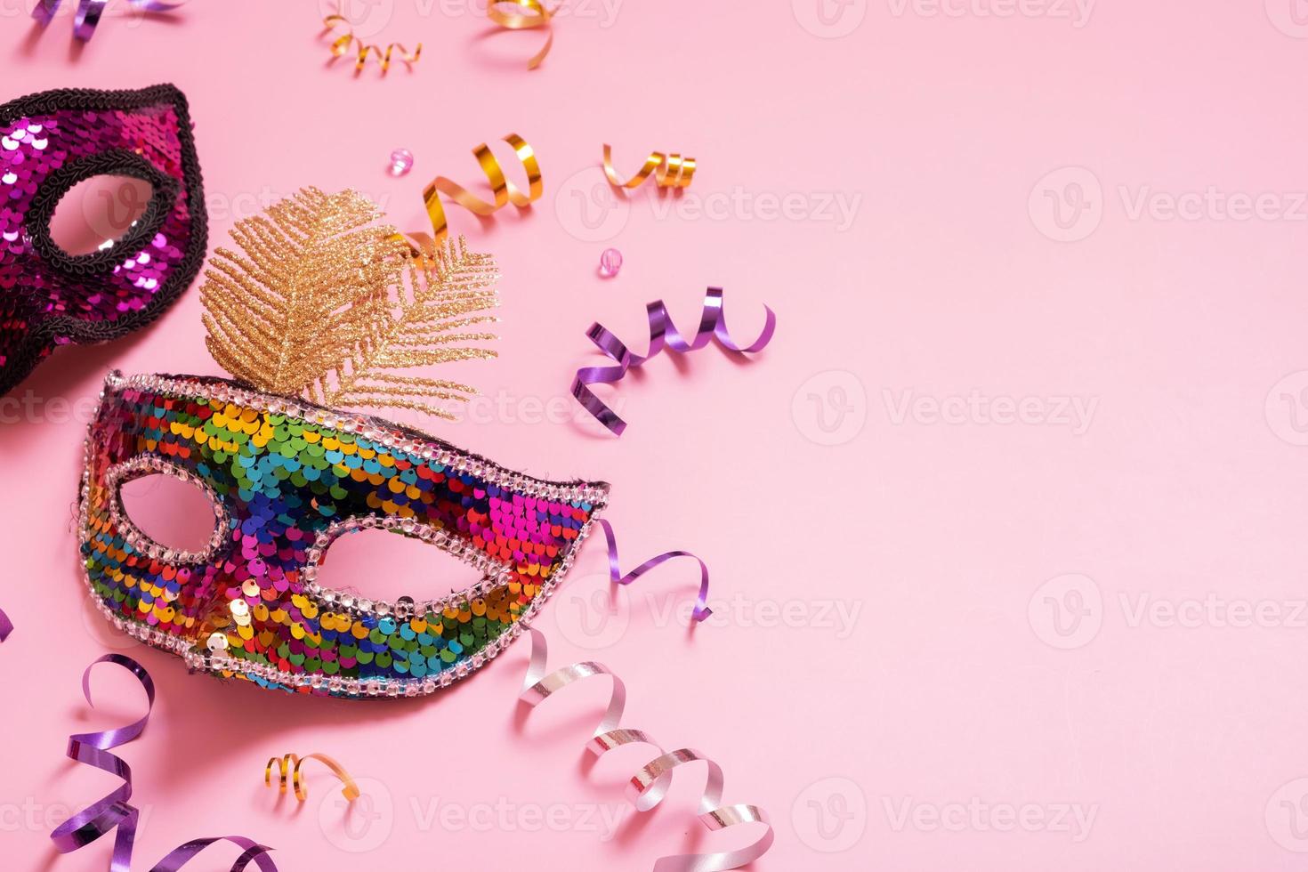 Festive face mask for carnival celebration on colored background photo