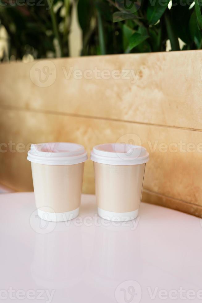 Two paper coffee cups in a cafe, coffee to go concept. Walks in the open air. photo