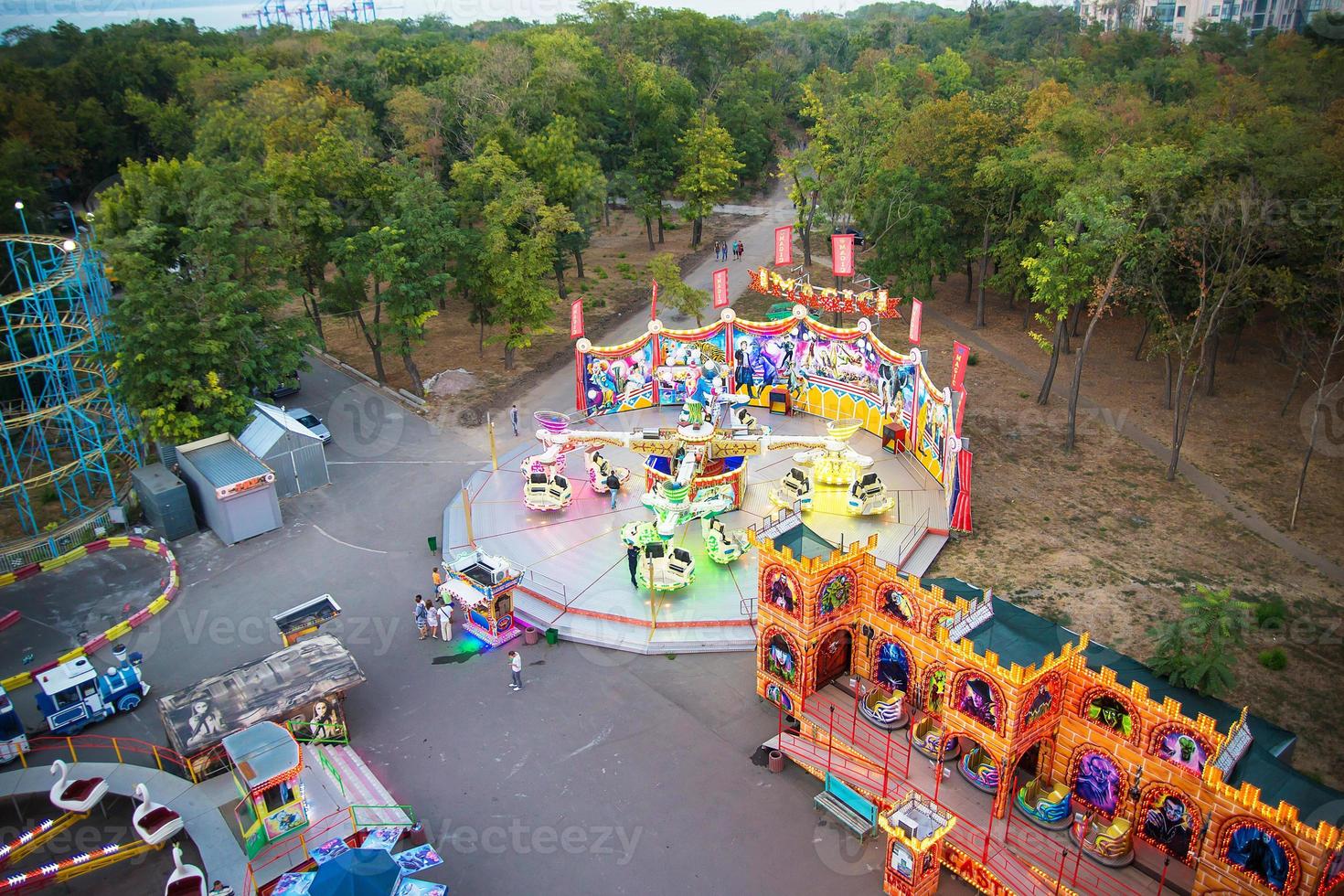 Ferris wheel and rollercoaster in motion at amusement park photo