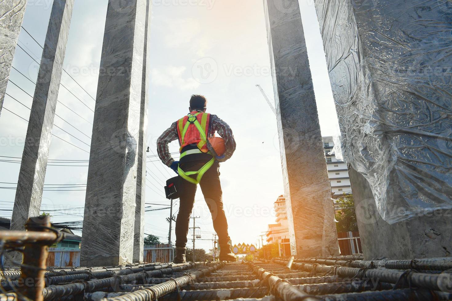 worker wearing equipment safety harness and safety line working at high place work at building site concepts of residential building under construction photo