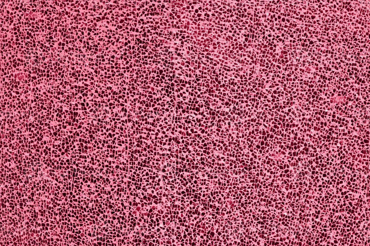 Abstract textured pattern small pieces of broken glass toned into Viva Magenta color. Inspired by Pantone color of the year 2023. Damaged window glass background. photo