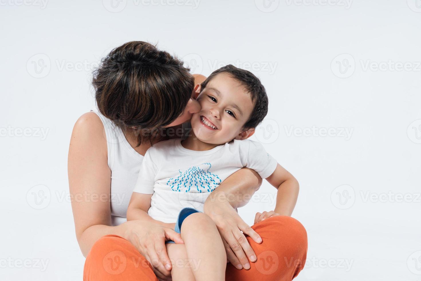 Mom hugs and kisses her little son. photo