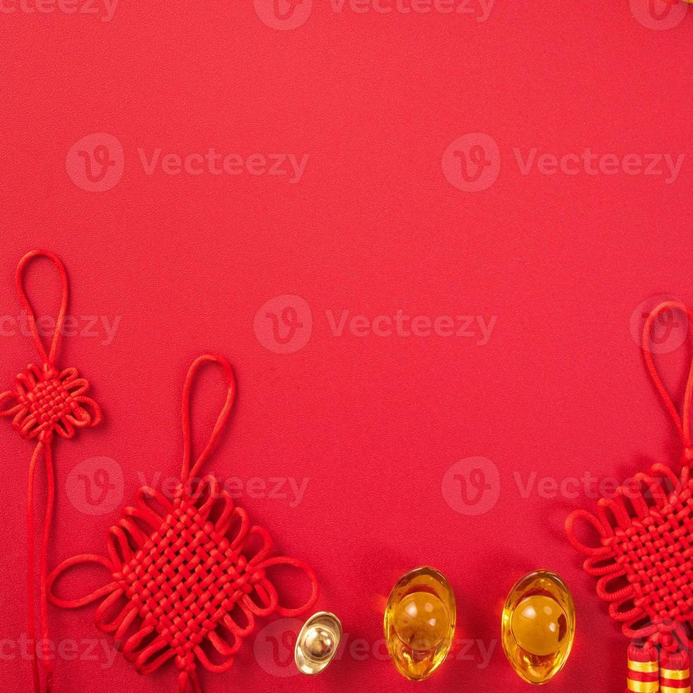 Design concept of Chinese lunar new year - Beautiful Chinese knot with plum blossom isolated on red background, flat lay, top view, overhead layout. photo