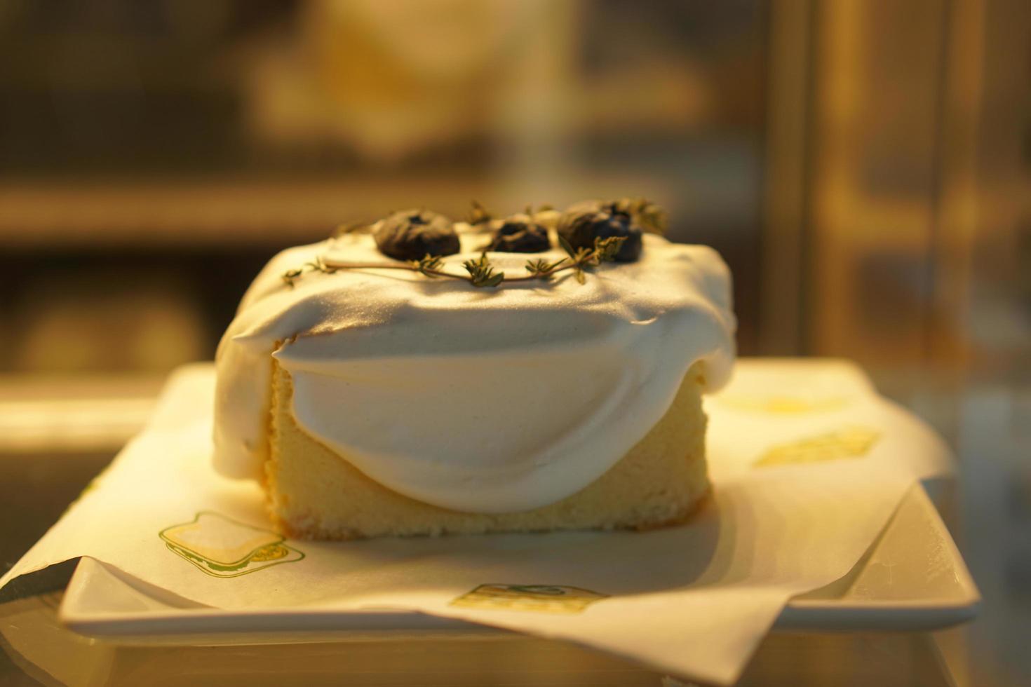 Cake in glass cabinet with orange lights photo