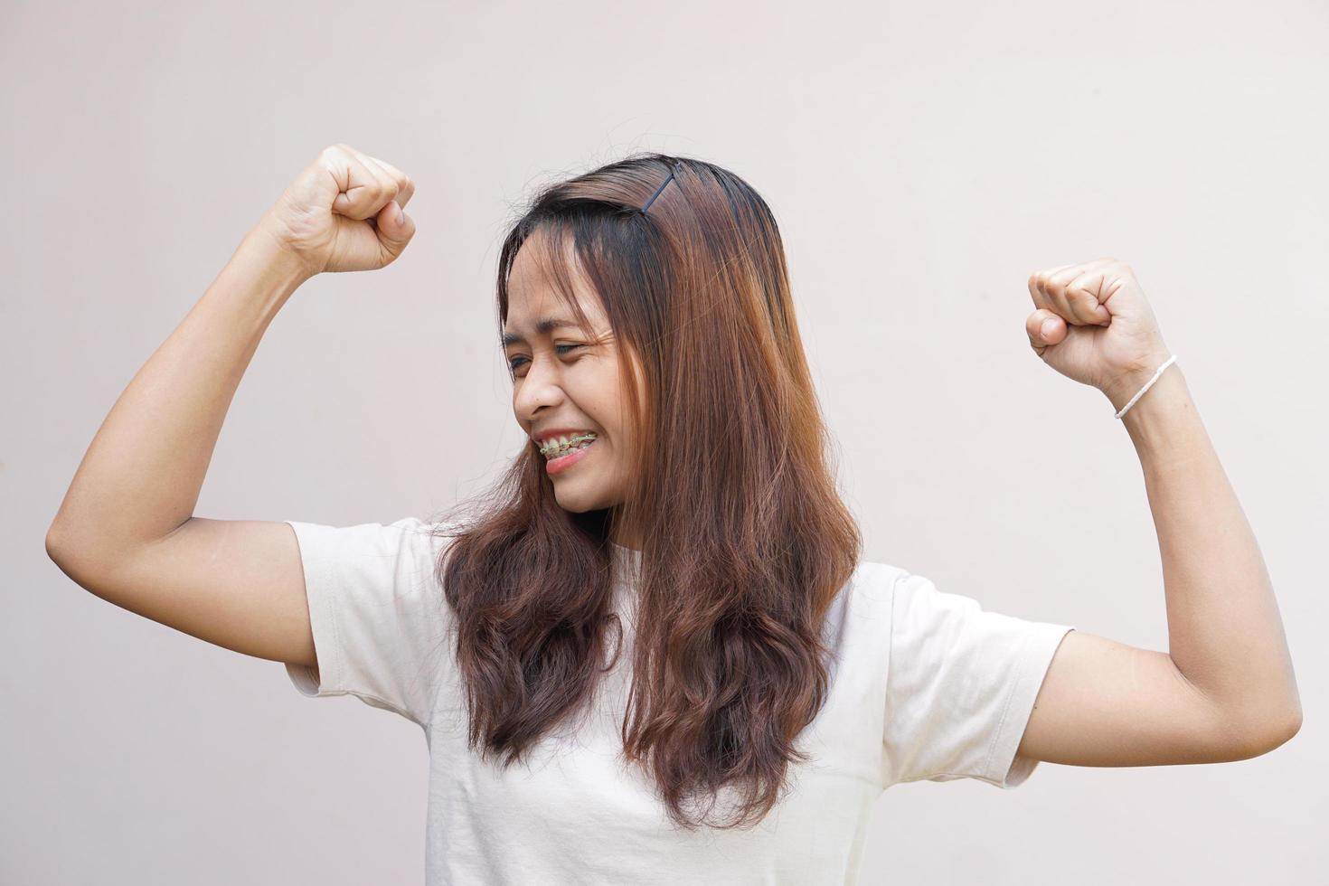 Asian women flex their muscles and show their strength. photo