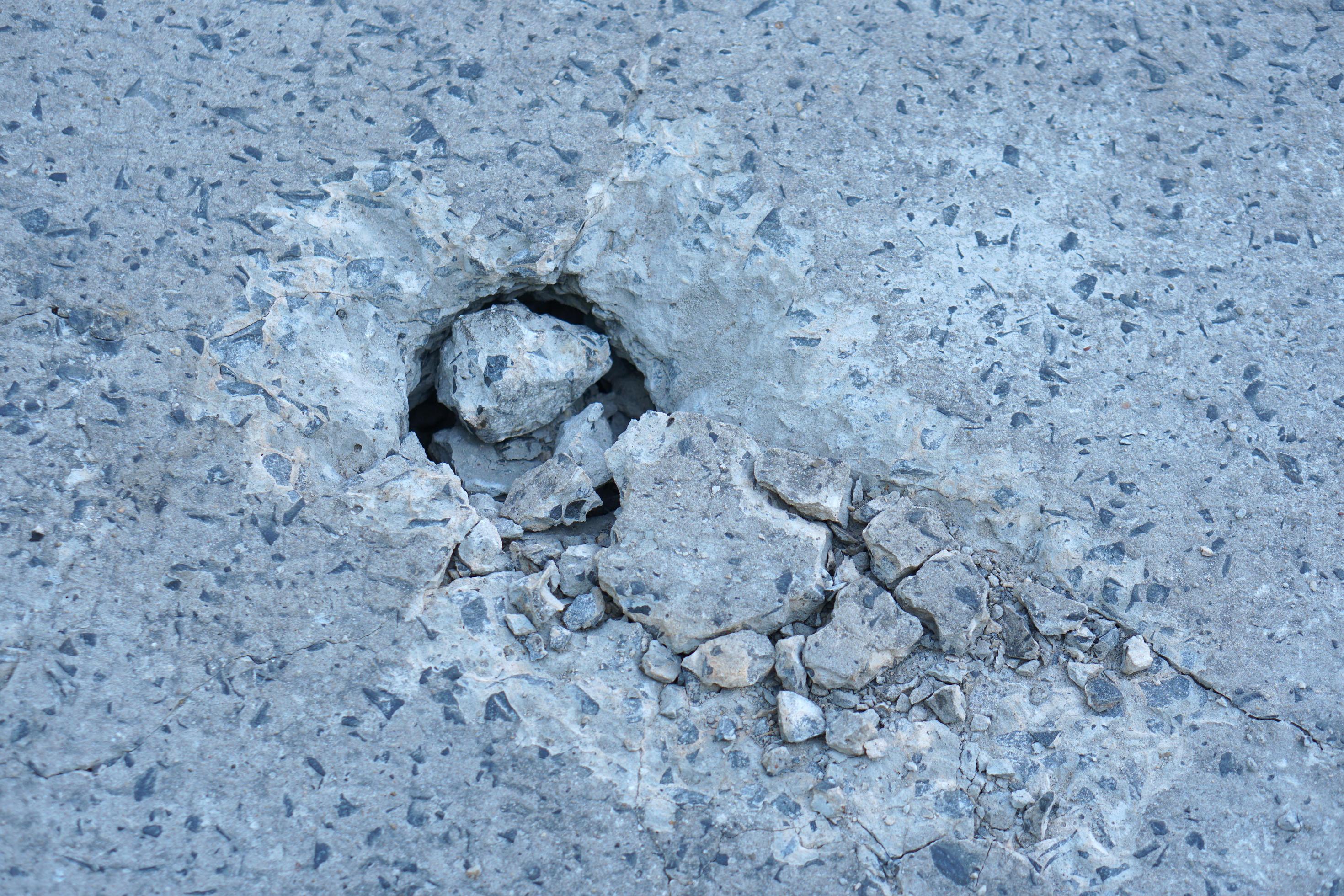 Holes are made by drilling from a machine for repairing concrete roads