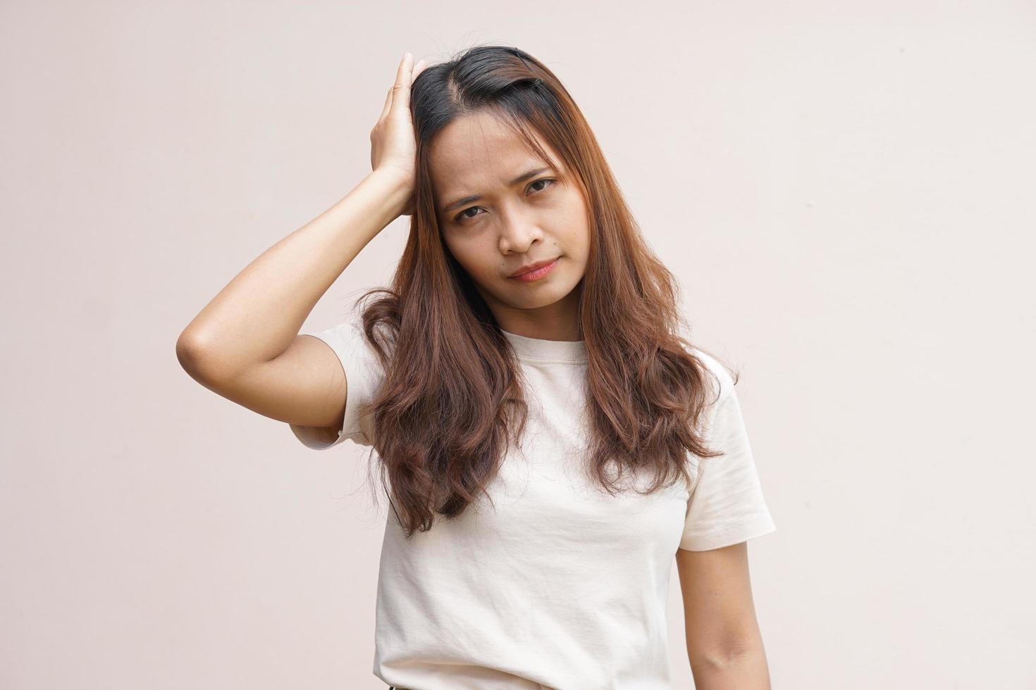 Asian women suffer from work stress. Put your hand on your head photo