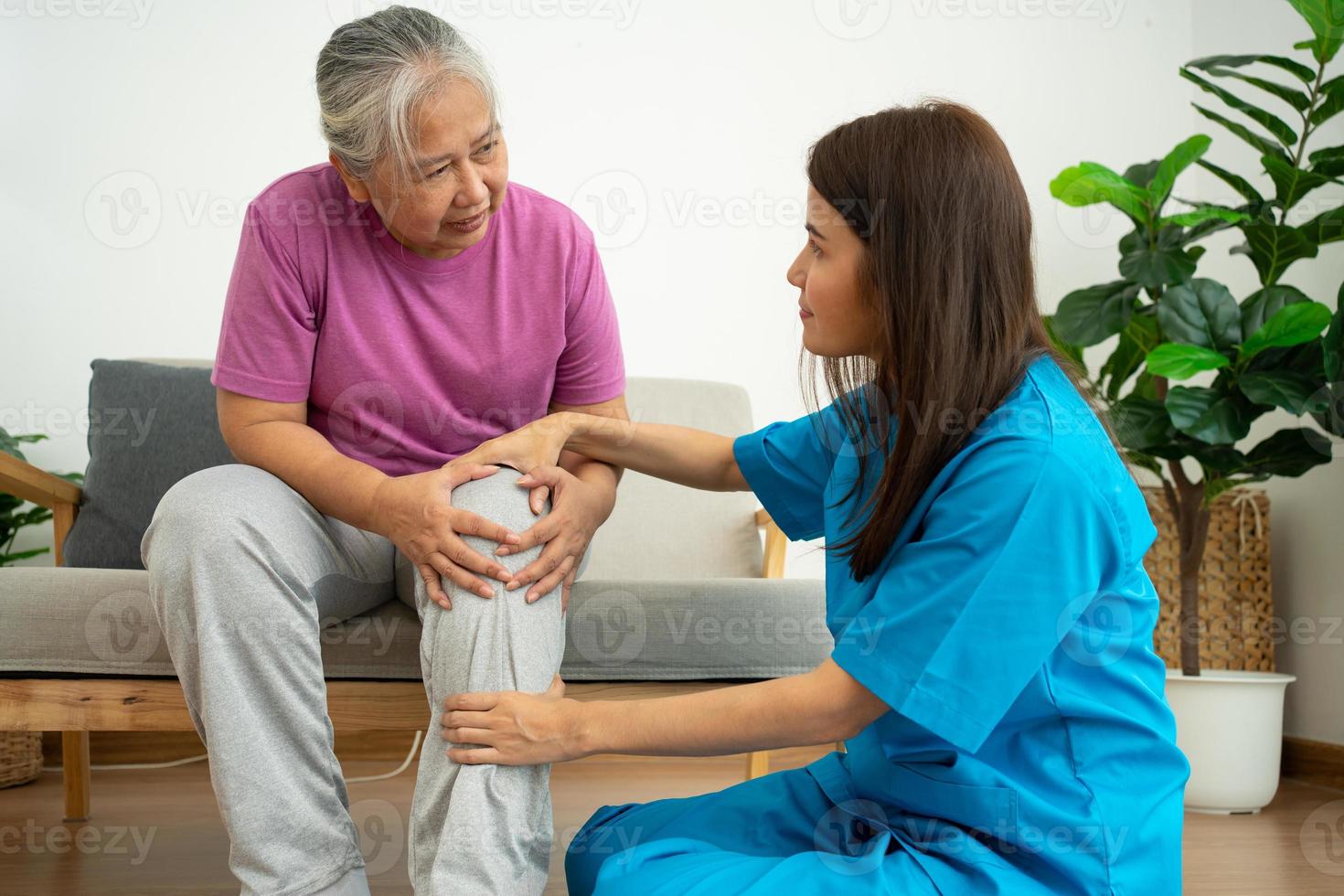 physiotherapist doctor or caregiver helping senior older woman stretching his hamstring and doing thigh or leg rehabilitation in exercise room, Osteoarthritis of the Knee and caregiver concept photo