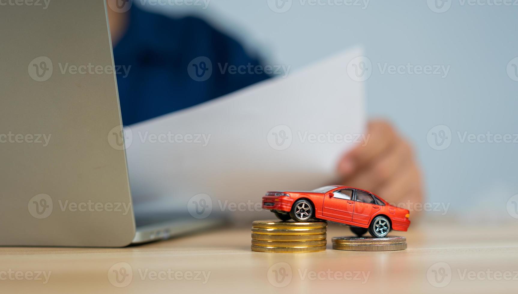 Unhappy Asian man holding a banknote and Making an account of income and expenses to pay the home loan and car loan, Concept loan payment and home insurance, economic problems, and inflation photo