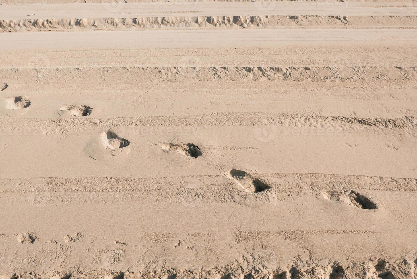 Traces of people in the sand of a beach. Pure sand on the beach as a background, texture. Selective focus. photo