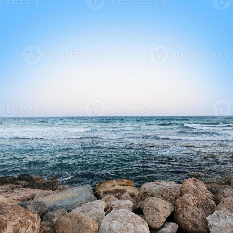Soft Wave Of Blue Ocean On Sandy Beach. Background. Selective focus. Seascape at sunset photo