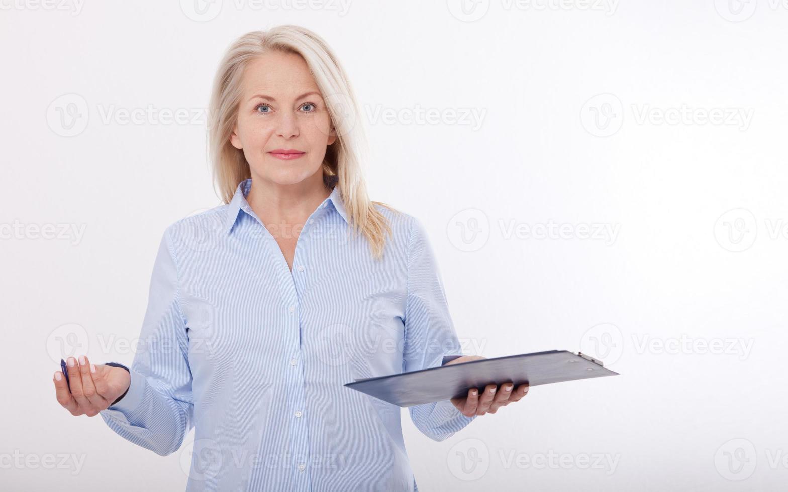 Business woman holds a pen and a folder with files isolated on white background photo