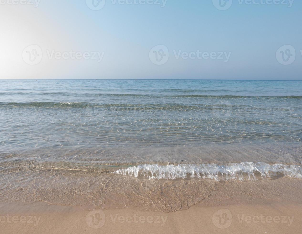 Soft Wave Of Blue Ocean On Sandy Beach. Tropical beach. Summer background.Selective focus. photo