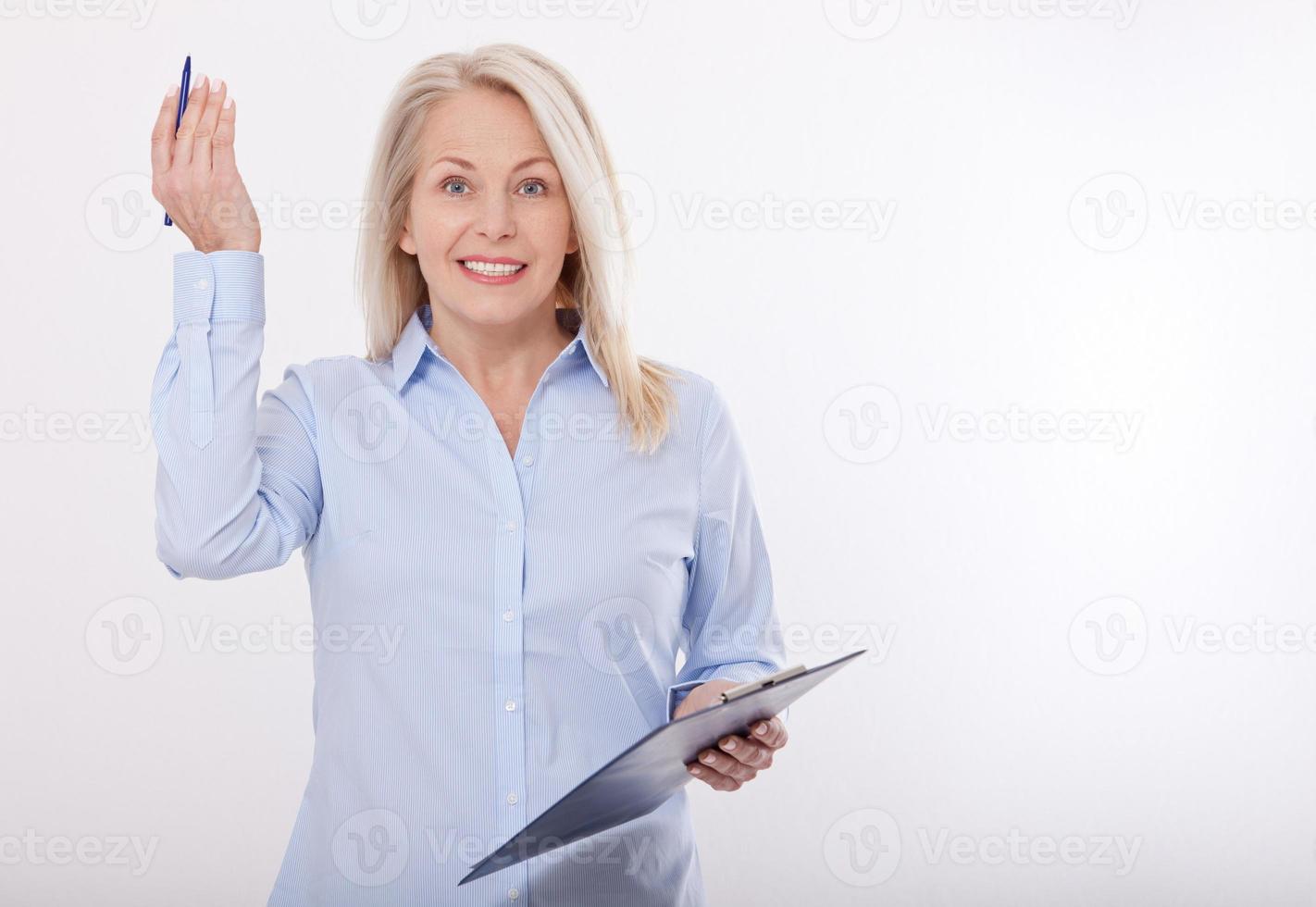 Business woman holds a pen and a folder with files isolated on white background photo