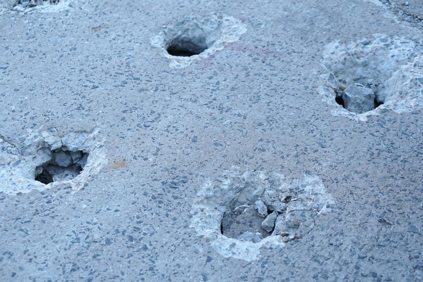 Holes are made by drilling from a machine for repairing concrete roads