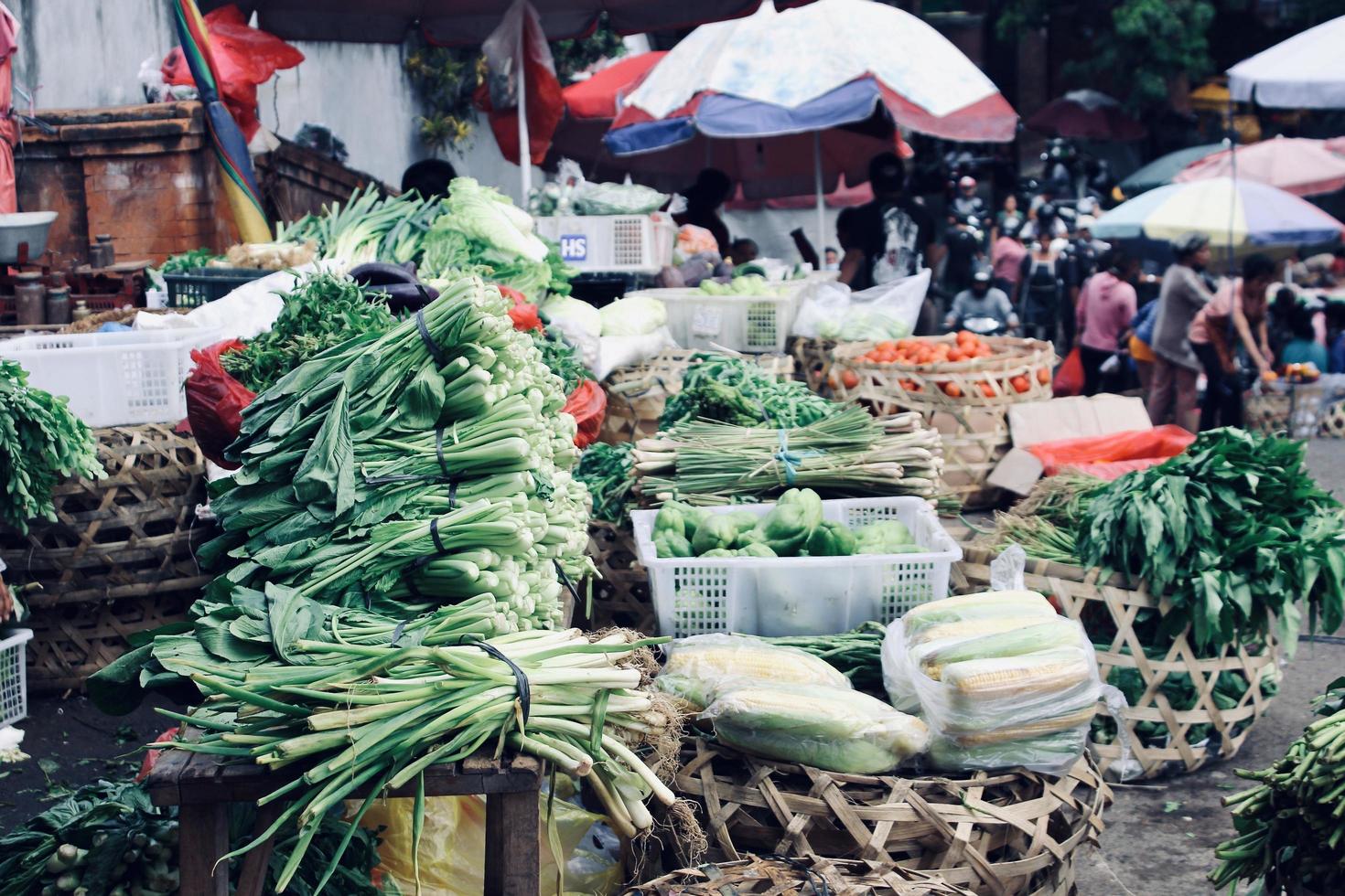 Badung, Bali - January 13 2023 Photo of various types of fresh green vegetables and fresh fruit in the Kumbasari Badung Traditional Market