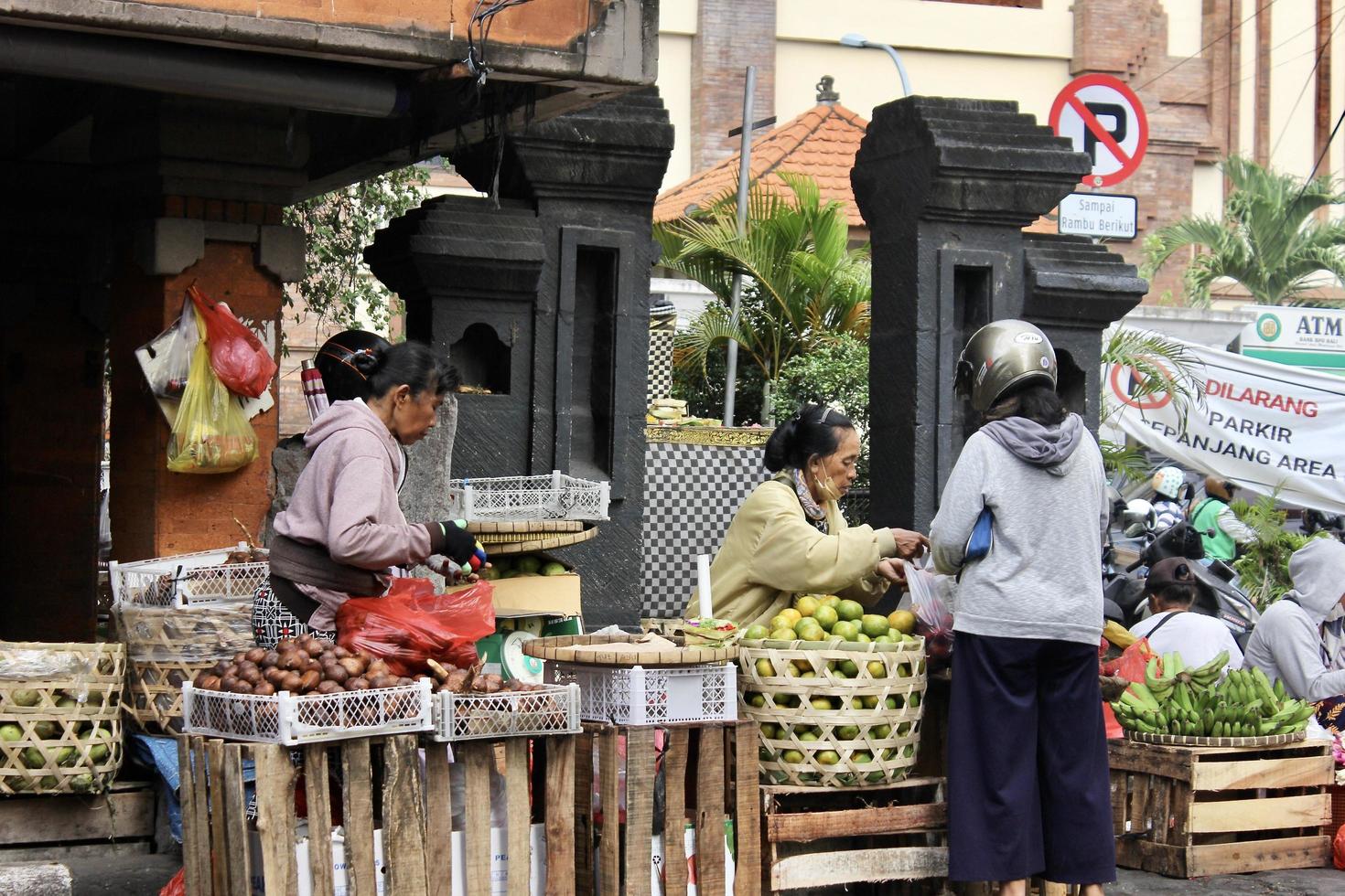 Badung Bali January 13 2023 A buyer is seen buying fresh fruit and vegetables at a traditional market in Bali photo