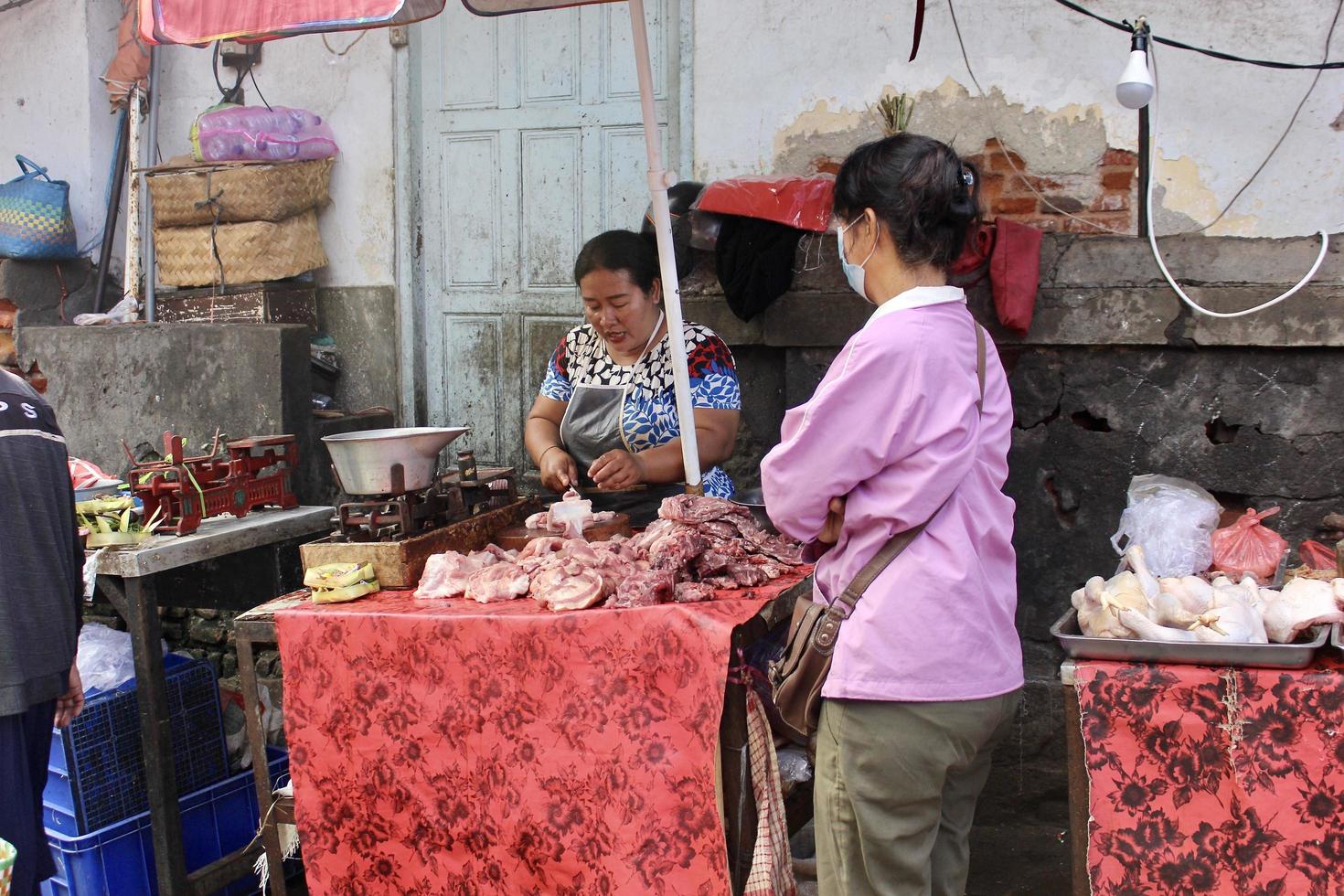 Badung Bali January 13 2023 A buyer is seen buying fresh fruit and vegetables at a traditional market in Bali photo