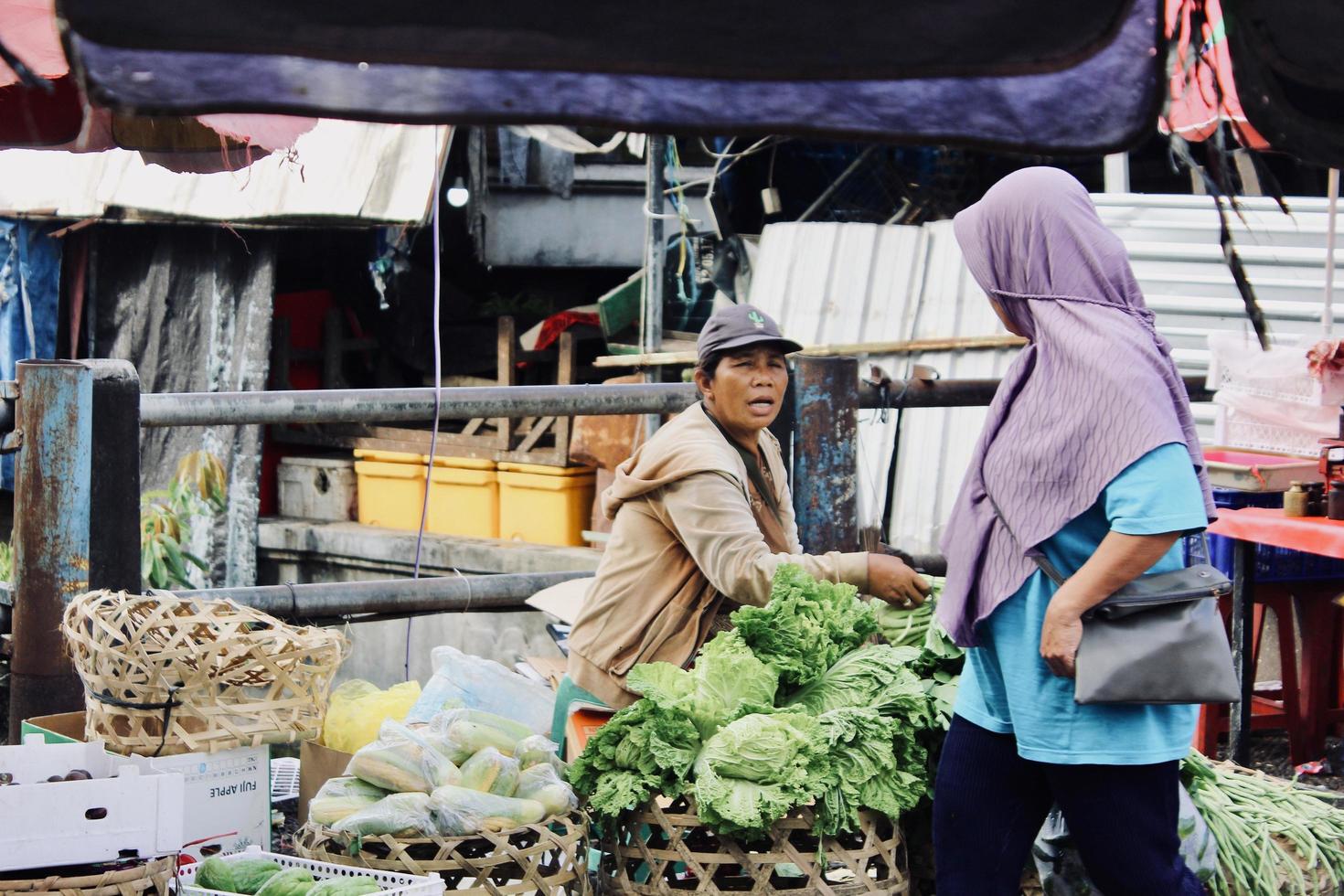 Badung Bali January 13 2023 A buyer is seen buying fresh fruit and vegetables at a traditional market in Bali photo