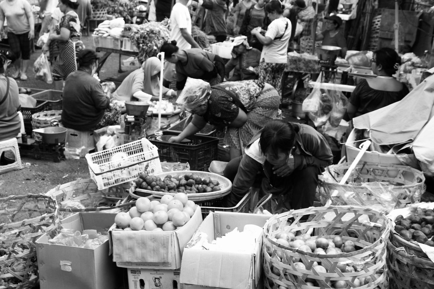 Badung, Bali - January 13 2023 Black and White Photo of a seller transacting with a buyer at the Badung Kumbasari Market