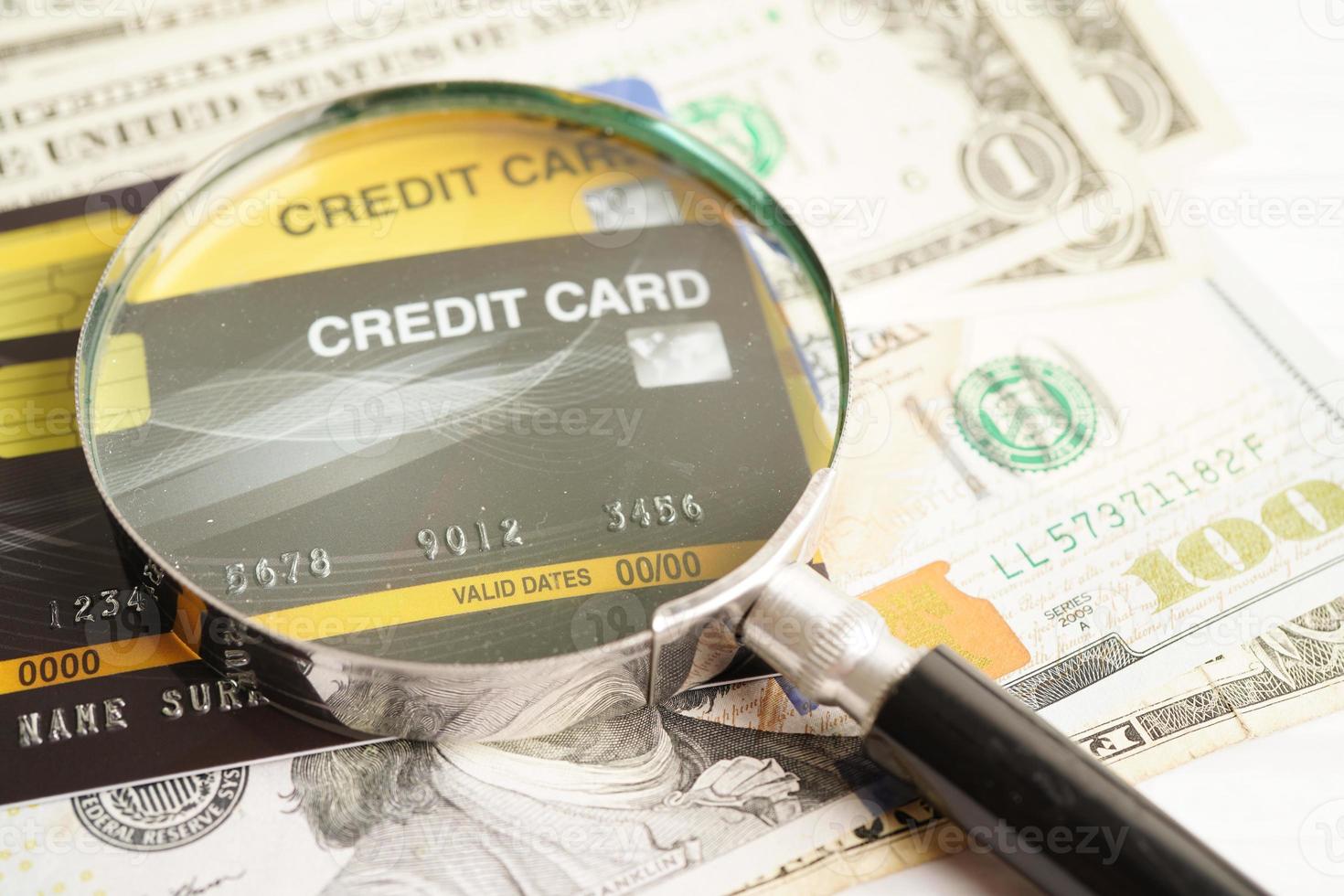 Credit card and magnifying glass for online shopping, security finance business concept. photo
