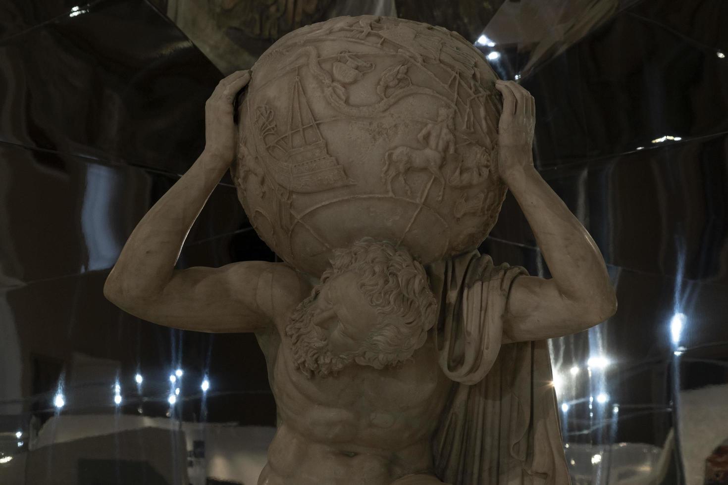 NAPLES, ITALY - FEBRUARY 1 2020 - Atlas holding the globe marble statue photo