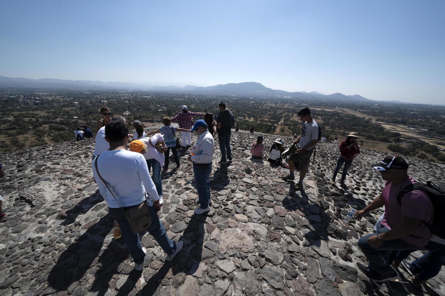 MEXICO CITY, MEXICO - JANUARY 30 2019 - Tourist climbing Teotihuacan pyramid mexico photo