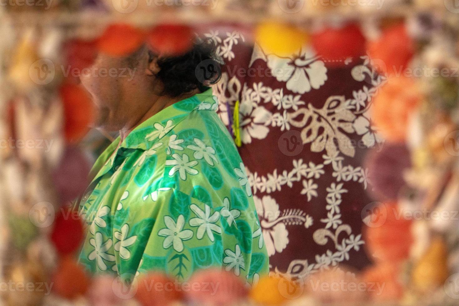 Colorful Polynesian man wuth sarong hand made at the mirror photo