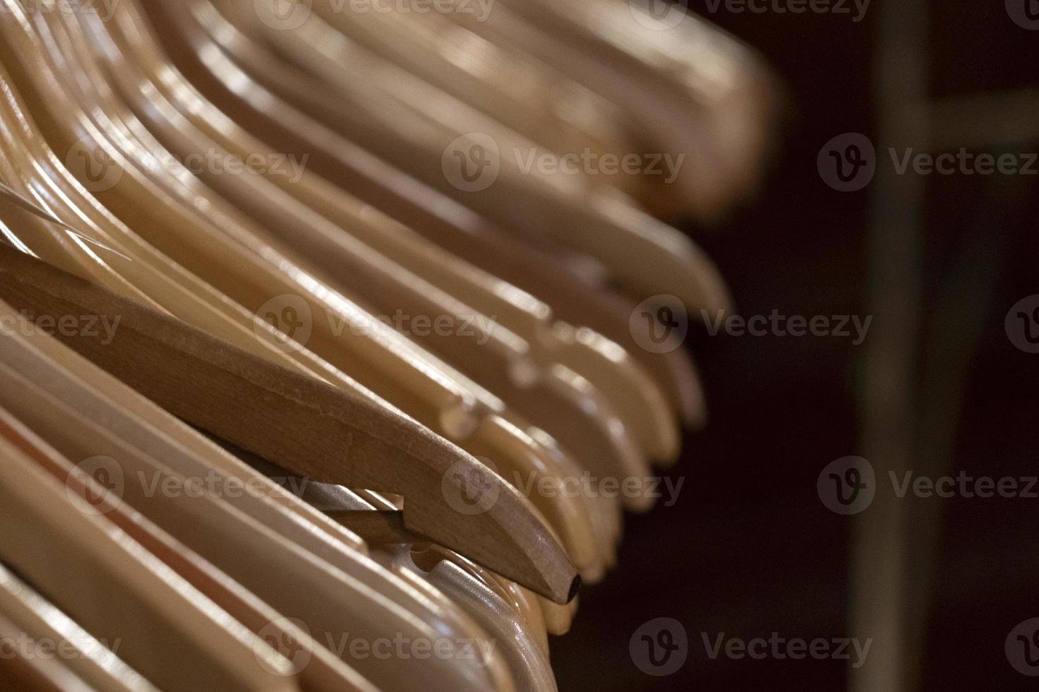 many wooden clothes hangers photo