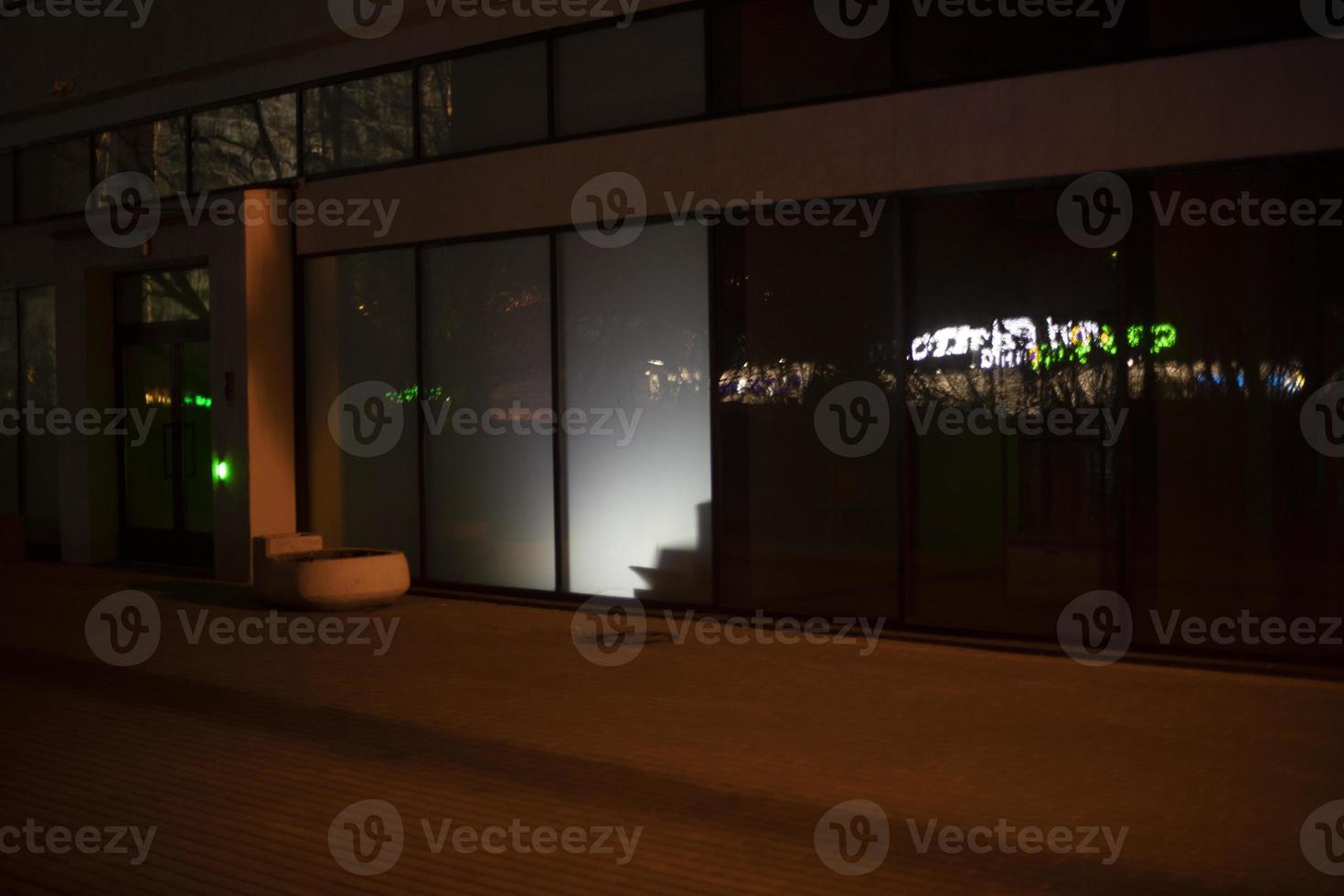 Light in display case at night. Light from building. Showcase details. photo