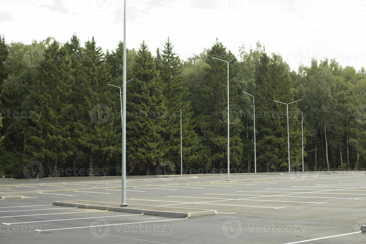 Empty parking in summer. Parking in park. Parking place. photo