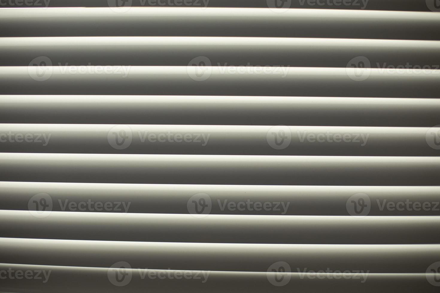 Blinds on window. Leakage of blinds. Window in afternoon. photo