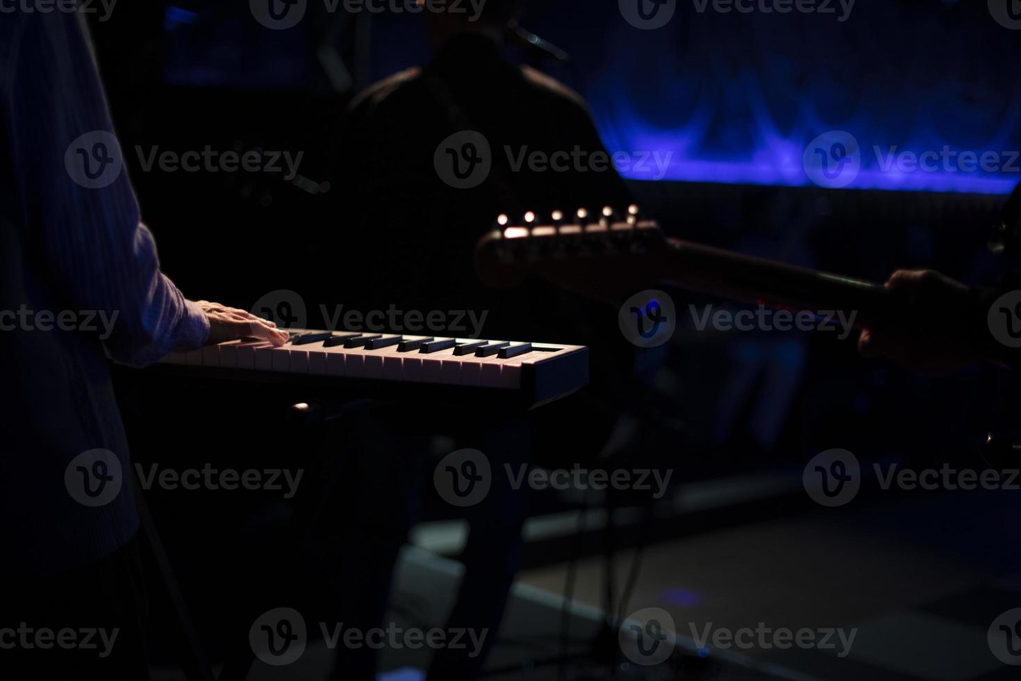 Musicians on stage. Playing musical instruments. Rock band performance. photo