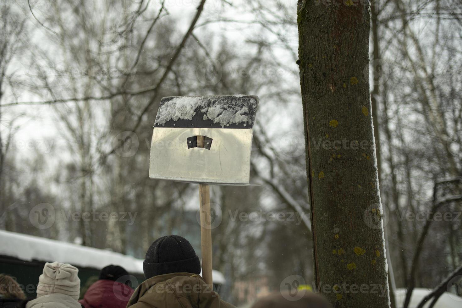 Steel shovel. People go to clean up. photo