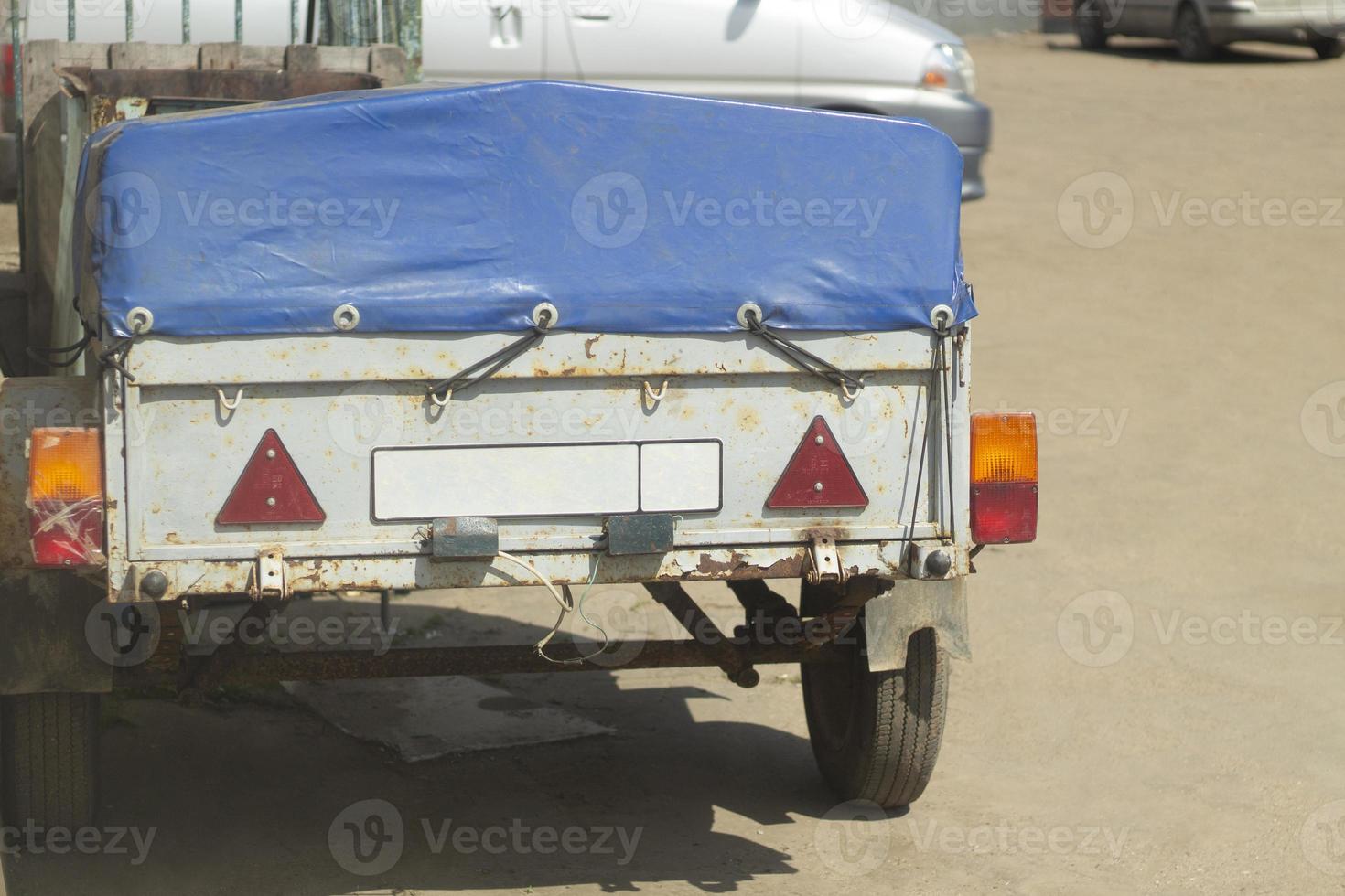 Trailer for car. Trailer in parking lot. Machine parts. photo