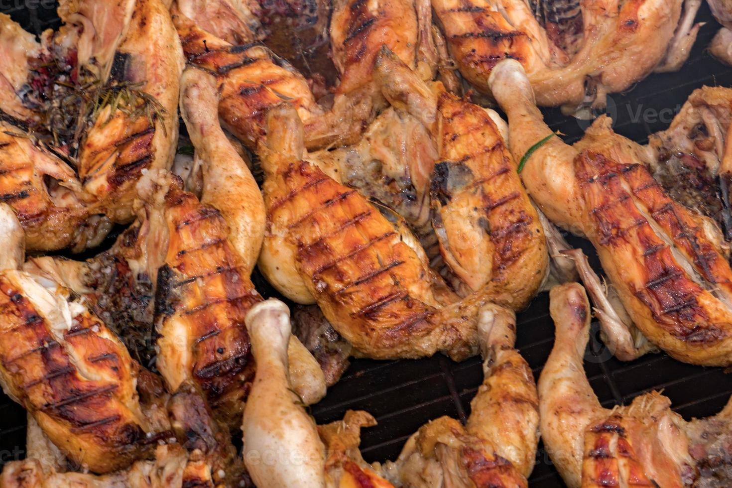 Many roasted chickens grilled at barbecue photo