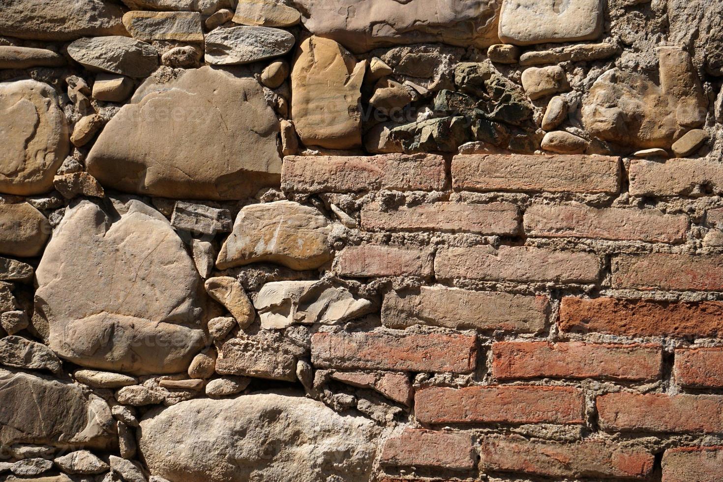 fondo de pared de piedra de casa antigua foto