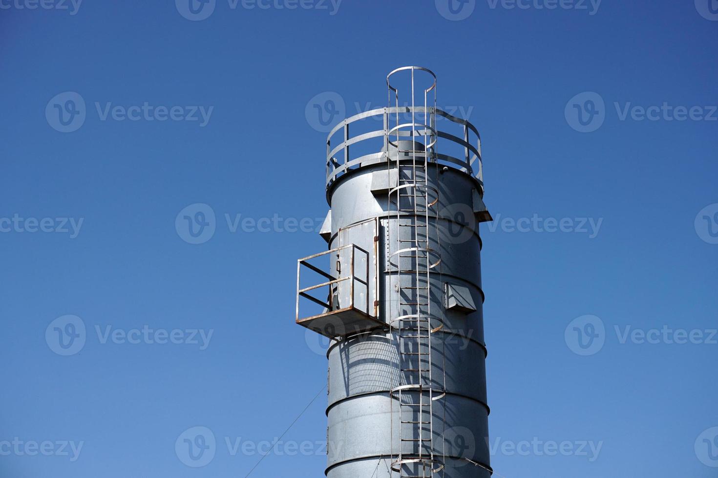 metallic silos on light blue sky photo
