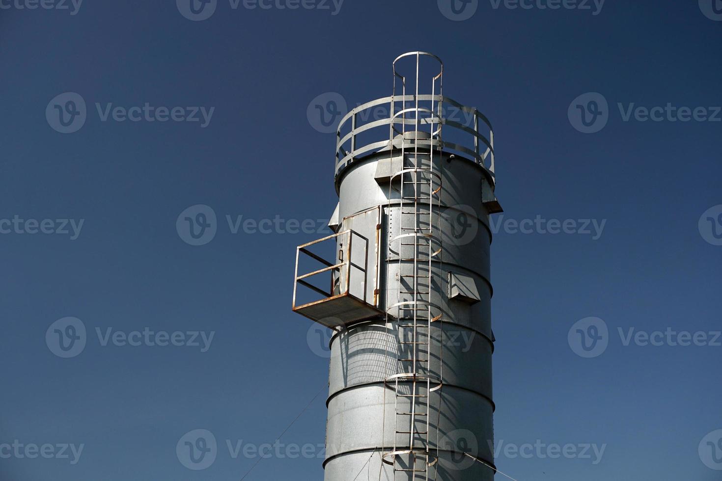 metallic silos on light blue sky photo