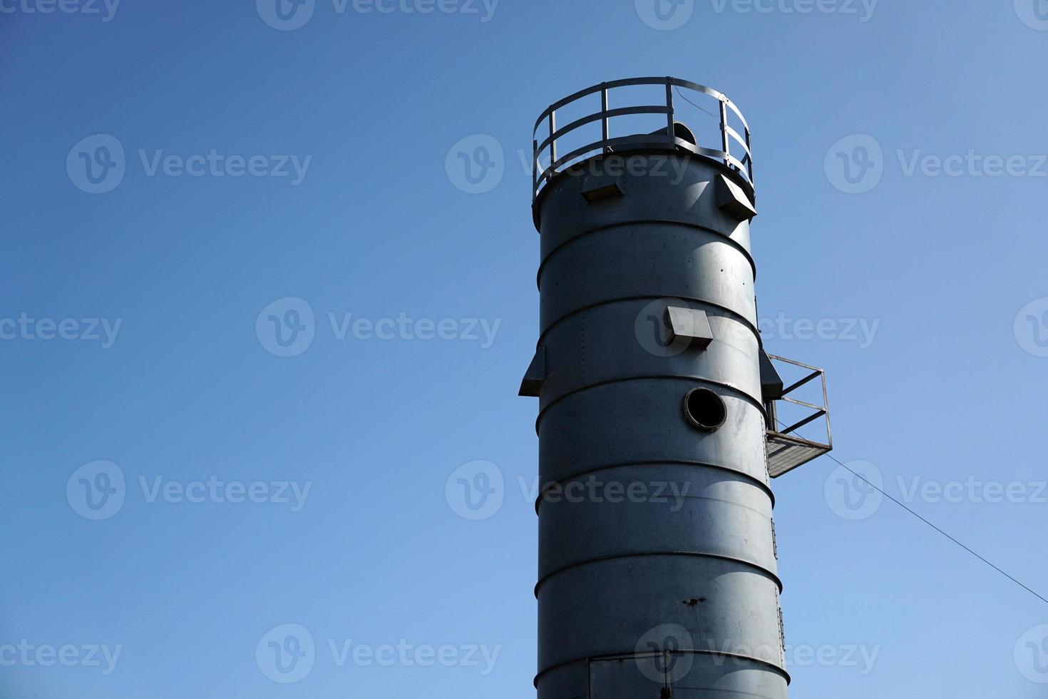 metallic silos on light blue sky photo