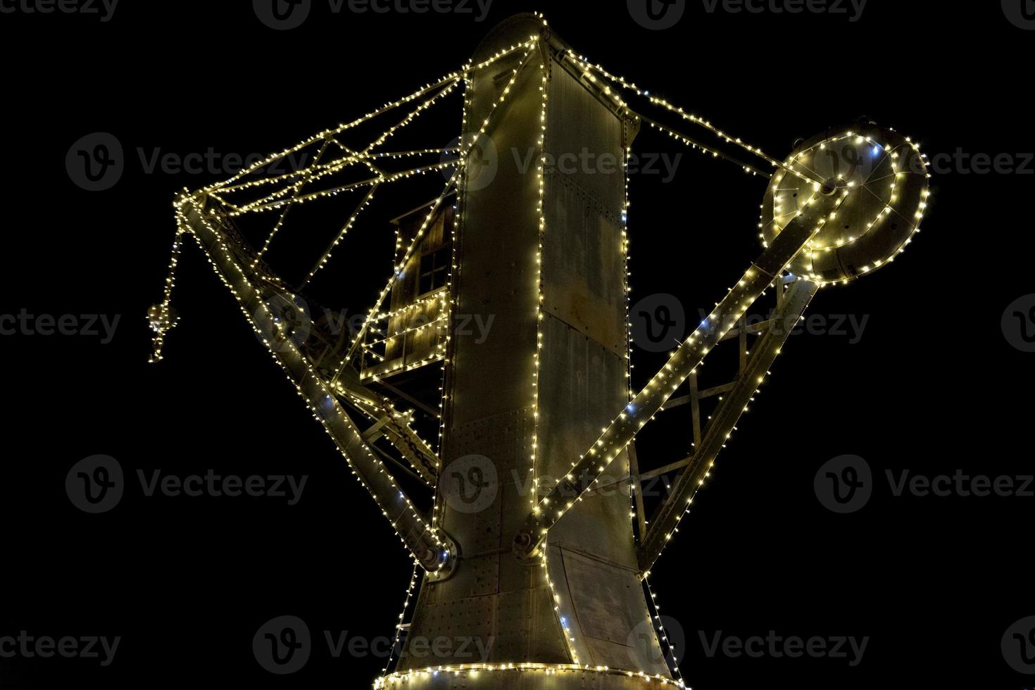 illuminated old crane in Genoa old harbor night view photo