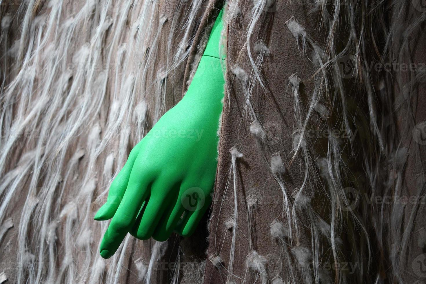 green hand on animal fur clothes detail photo