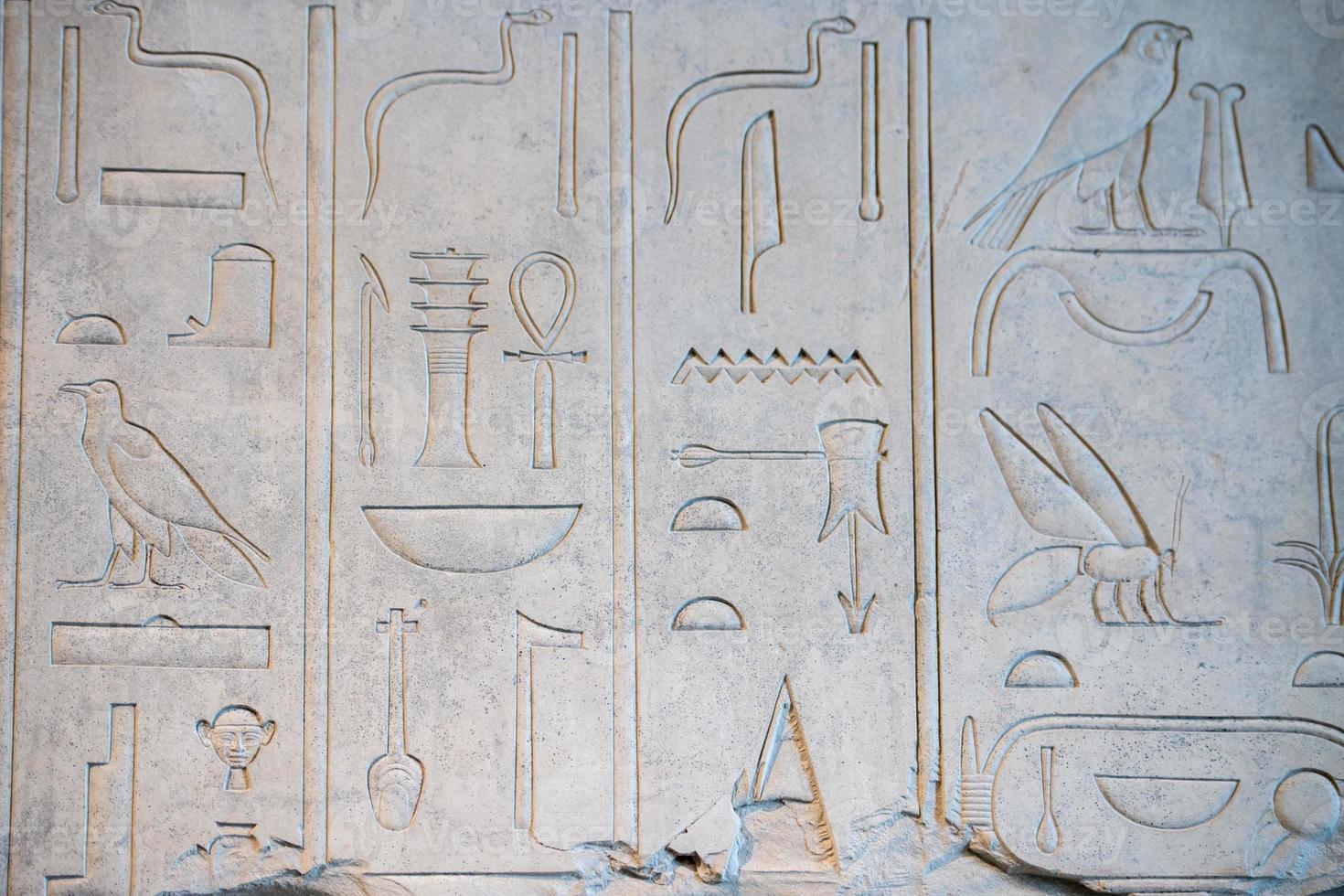 ancient hieroglyphs on stone detail photo