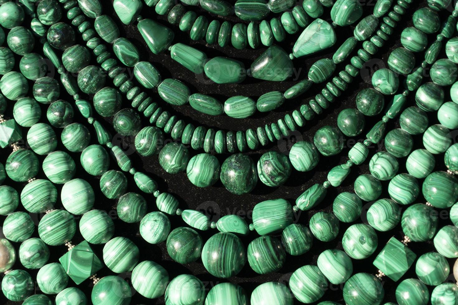 Malachite necklage earrings jewelry on display stand in a shop market photo